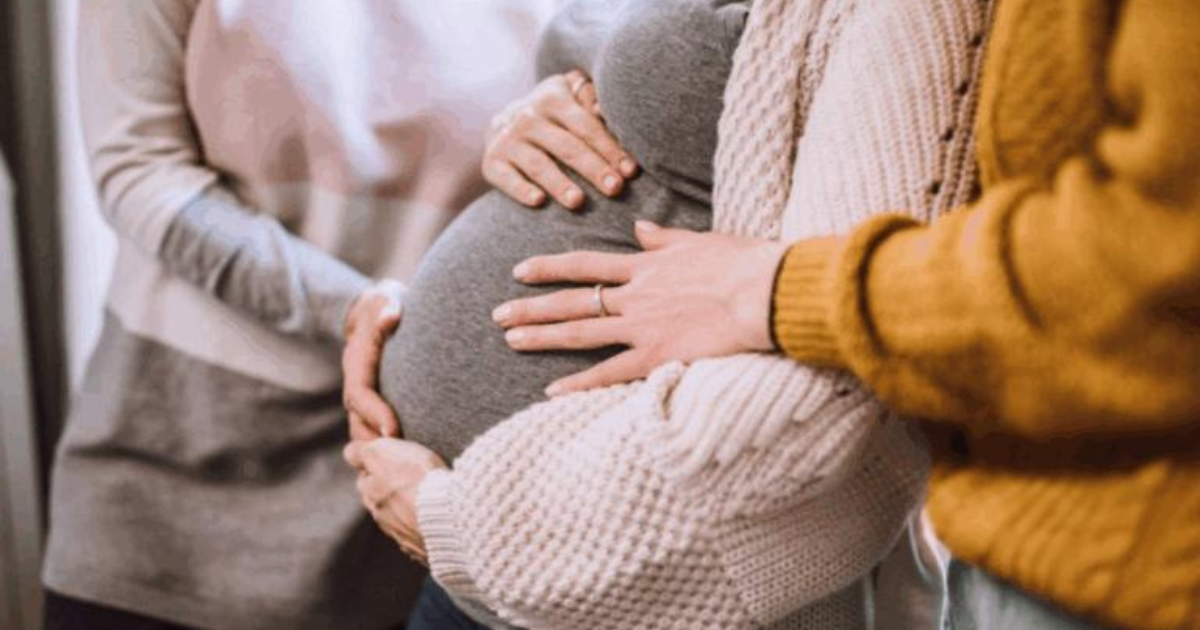 Pregnant woman with hands on belly